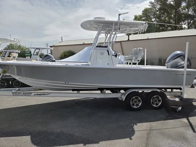 Slide: The Image of A gray 2020 Sportsman Masters 247 Bay Boat on a trailer in an outdoor setting. - 6