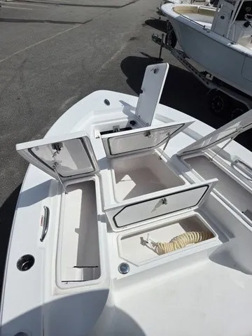 Slide: The Image of The image shows the bow of a Sportsman Masters 247 Bay Boat with multiple open storage compartments. - 10