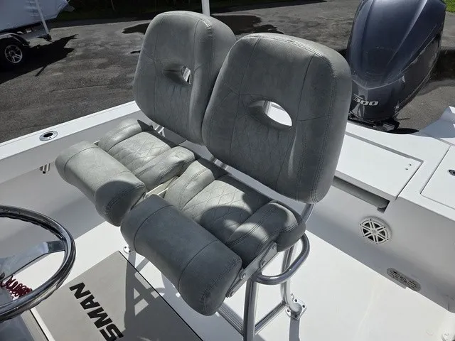 Slide: The Image of Two padded seats on a 2020 Sportsman Masters 247 Bay Boat, with an outboard motor in the background. - 22