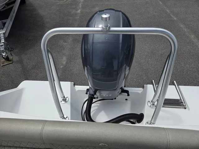 Slide: The Image of The image shows the engine of a 2021 Sportsman Heritage 211 Center Console boat. - 21