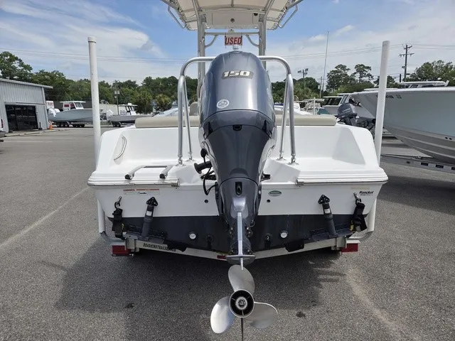 Slide: The Image of The image shows the rear of a 2021 Sportsman Heritage 211 Center Console boat with an outboard motor. - 22