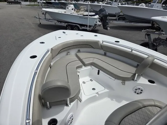 Slide: The Image of The image shows the bow area of a 2021 Sportsman Heritage 211 Center Console boat with cushioned seating. - 7