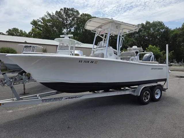 The Image of A white Sportsman Heritage 211 Center Console boat from 2021 is on a trailer. - 1