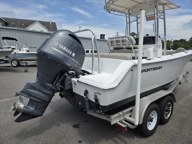 Slide: The Image of A 2021 Sportsman Heritage 211 Center Console boat on a trailer. It features a Yamaha outboard motor. - 4