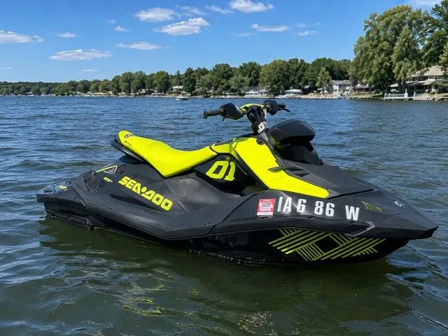 The Image of A 2023 Sea-Doo Spark Trixx 2-up jet ski floats on a calm lake. - 1
