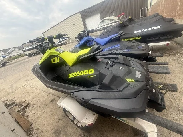 Slide: The Image of A Sea-Doo Spark Trixx jet ski in bright yellow and black sits on a trailer in a storage area. - 10