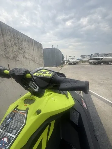 Slide: The Image of A bright yellow Sea-Doo jet ski is parked on a concrete lot, surrounded by other boats. - 7