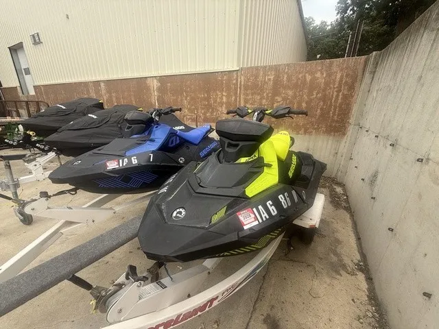 Slide: The Image of A 2023 Sea-Doo Spark Trixx 2-up Rotax 900 H.O. ACE IBR in bright yellow sits on a trailer next to other jet skis. - 11