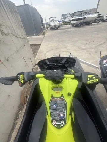 Slide: The Image of A Sea-Doo Spark Trixx jet ski on concrete, surrounded by other boats. - 5