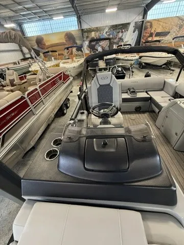 Slide: The Image of The image shows the cockpit of a 2021 Harris Solstice 250 SLDH in a showroom. - 14