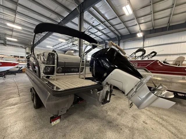 Slide: The Image of A 2021 Harris Solstice 250 SLDH is in a warehouse. The outboard motor is prominently visible. - 4