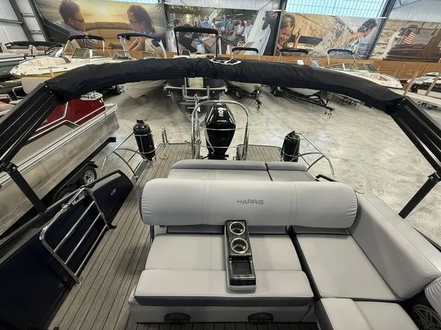 Slide: The Image of The image shows the interior of a 2021 Harris Solstice 250 SLDH with gray upholstery and a central cup holder. - 25