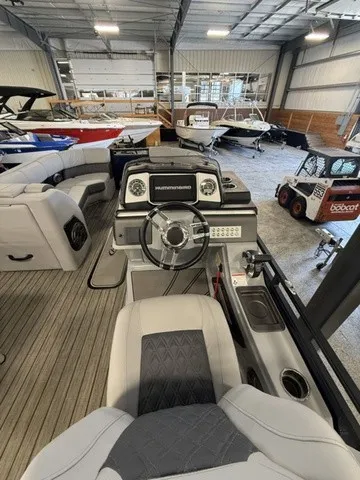 Slide: The Image of The image shows the cockpit of a 2021 Harris Solstice 250 SLDH in a showroom. - 20