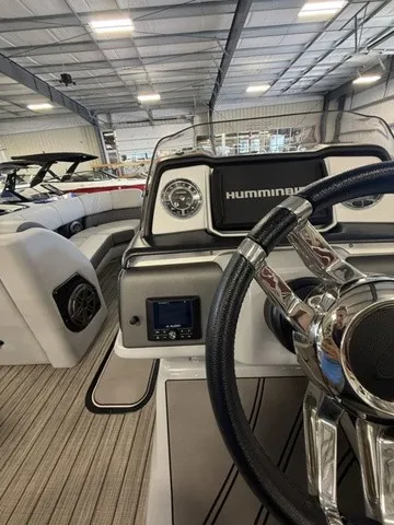 Slide: The Image of The image shows the cockpit of a 2021 Harris Solstice 250 SLDH inside a warehouse. - 21