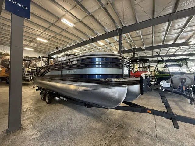 Slide: The Image of 2021 Harris Solstice 250 SLDH pontoon boat in a storage facility. - 3
