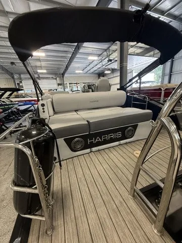 Slide: The Image of The image shows a 2021 Harris Solstice 250 SLDH boat in a storage facility. - 7