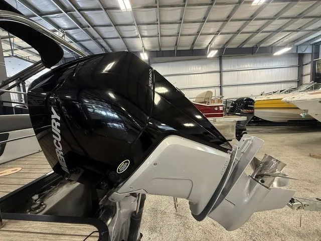 Slide: The Image of A Mercury outboard motor is mounted on a 2021 Harris Solstice 250 SLDH, inside a storage facility. - 5