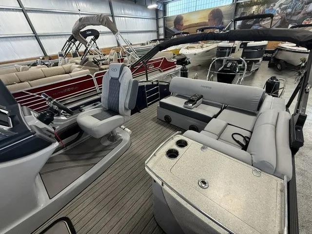 Slide: The Image of The image shows the interior of a 2021 Harris Solstice 250 SLDH with gray seating and a modern helm. - 19