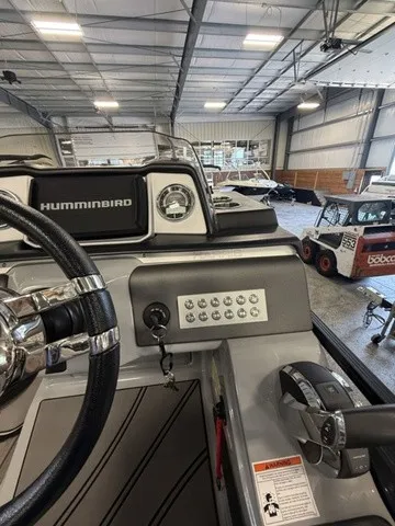 Slide: The Image of The image shows the cockpit of a 2021 Harris Solstice 250 SLDH inside a warehouse. - 22