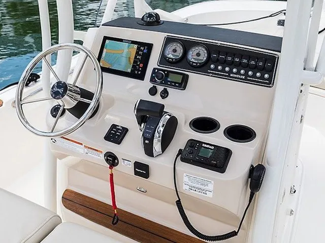Slide: The Image of The image shows the helm of a Boston Whaler 210 Montauk with modern instruments and controls. - 12