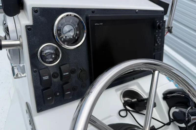 Slide: The Image of Dashboard of 2021 Express X23 BAY boat with steering wheel and control panel. - 14