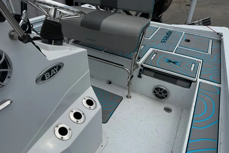 Slide: The Image of 2021 Express X23 BAY boat interior with seating and storage compartments. - 17
