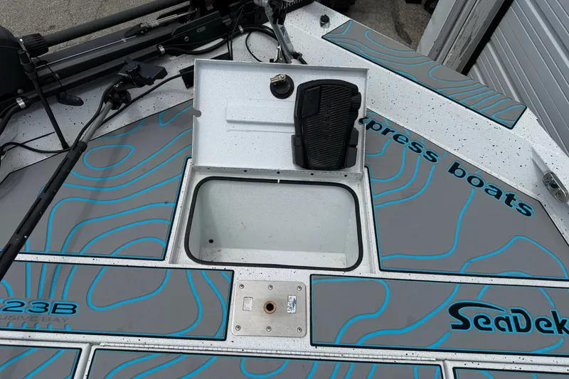 Slide: The Image of 2021 Express X23 BAY boat deck with SeaDek flooring and storage compartment open. - 22