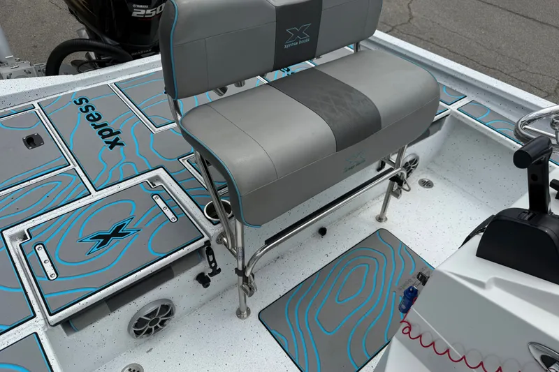 Slide: The Image of 2021 Express X23 BAY boat interior with seating and custom flooring design. - 21
