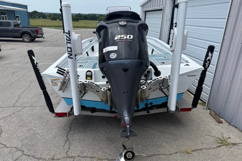 Slide: The Image of 2021 Express X23 BAY boat with powerful 250 horsepower engine, parked near a garage. - 3