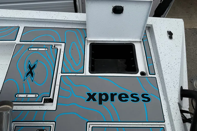 Slide: The Image of 2021 Express X23 BAY boat deck with blue accents and storage compartments. - 20