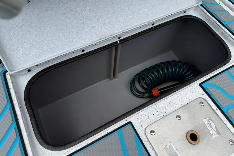 Slide: The Image of Storage compartment of 2021 Express X23 BAY boat with coiled hose inside. - 19