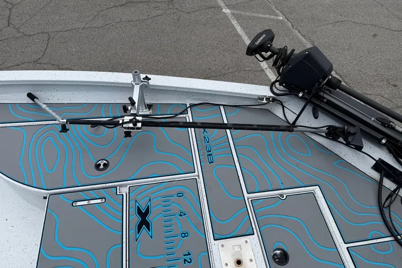 Slide: The Image of 2021 Express X23 BAY boat deck with blue contour design and Garmin equipment. - 10