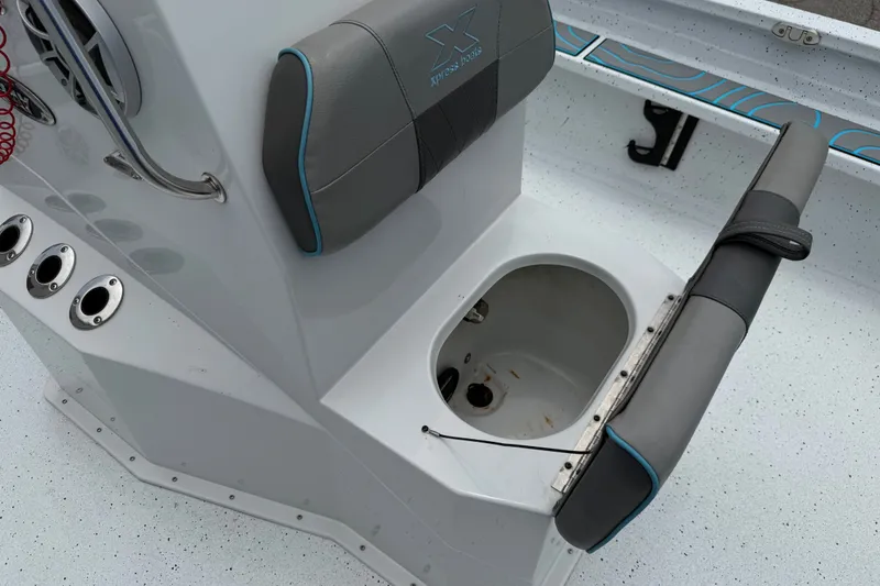 Slide: The Image of 2021 Express X23 BAY boat interior with seating and storage compartment. - 16