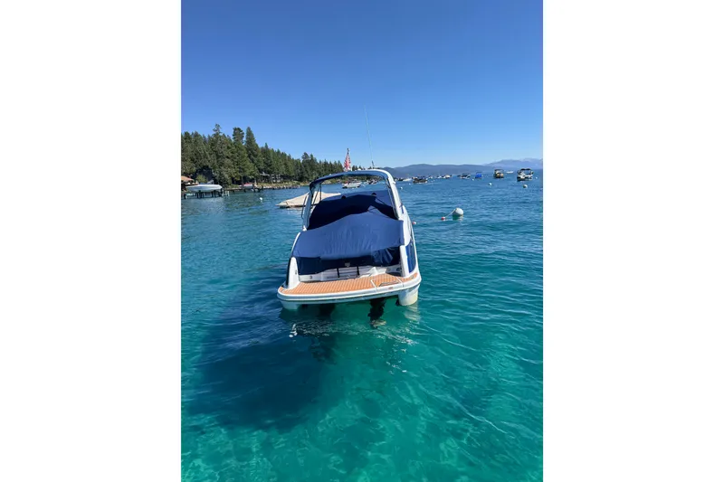 Slide: The Image of 2008 Formula 310 Sun Sport boat on clear blue water, surrounded by scenic landscape. - 3