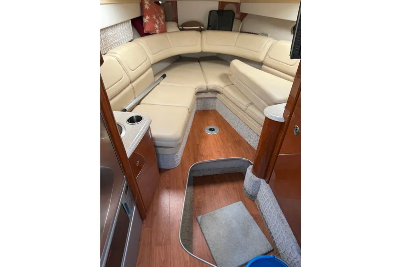 Slide: The Image of Interior of a 2008 Formula 310 Sun Sport boat with beige seating and wood flooring. - 13