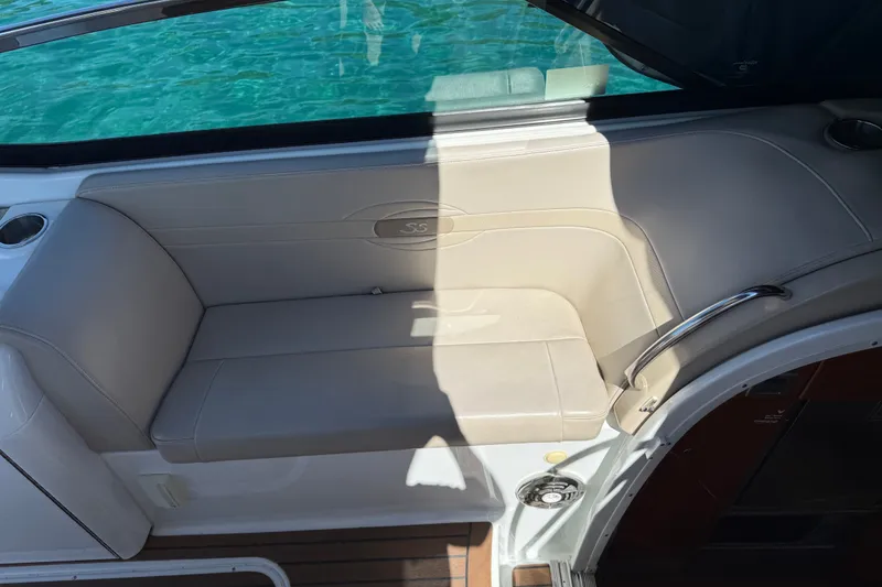 Slide: The Image of Beige seating area on a 2008 Formula 310 Sun Sport boat, near turquoise water. - 6