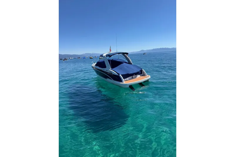 Slide: The Image of 2008 Formula 310 Sun Sport boat on clear blue water under a sunny sky. - 4