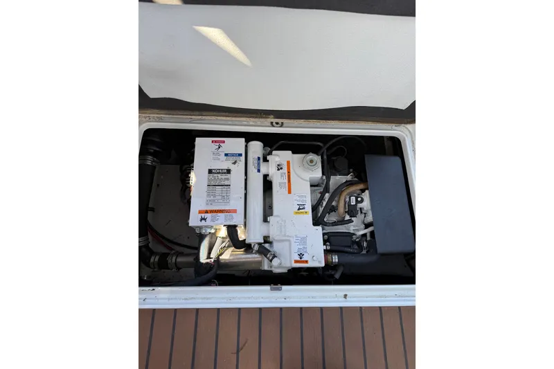 Slide: The Image of Engine compartment of a 2008 Formula 310 Sun Sport boat, featuring a Kohler generator. - 19