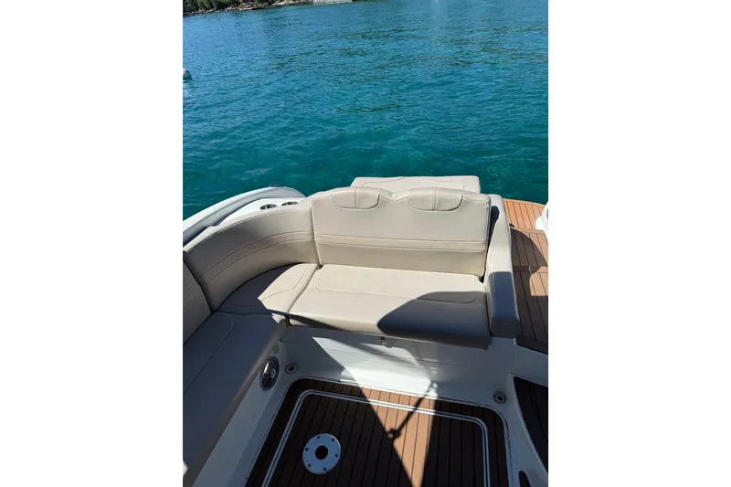Slide: The Image of 2008 Formula 310 Sun Sport boat interior with beige seating and teak flooring on blue water. - 8