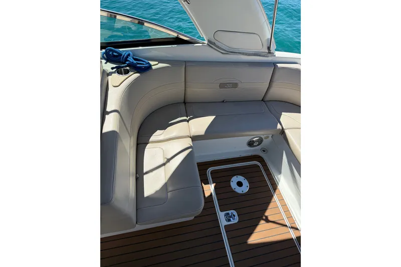 Slide: The Image of 2008 Formula 310 Sun Sport boat interior with beige seating and wooden deck. - 9