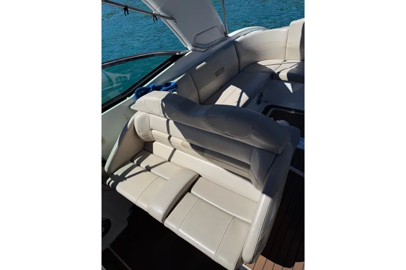 Slide: The Image of 2008 Formula 310 Sun Sport boat interior with beige leather seating and blue waters in the background. - 7