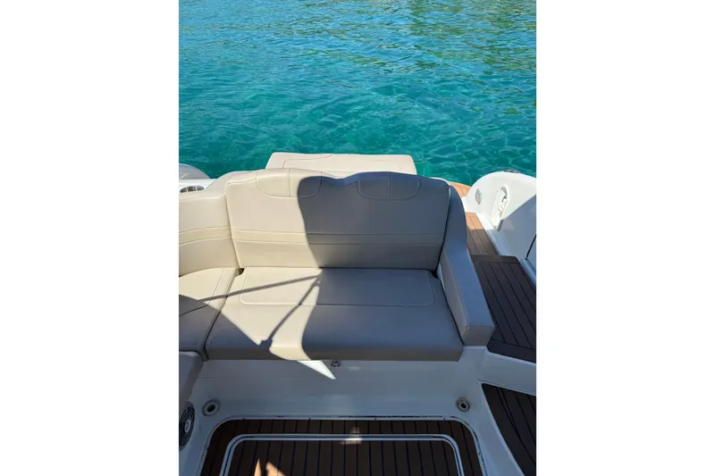 Slide: The Image of 2008 Formula 310 Sun Sport boat with beige seating and teak flooring on clear water. - 10