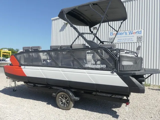 Slide: The Image of A 2023 Sea-Doo Switch Sport 21 on a trailer, featuring a black canopy and modern seating. - 2