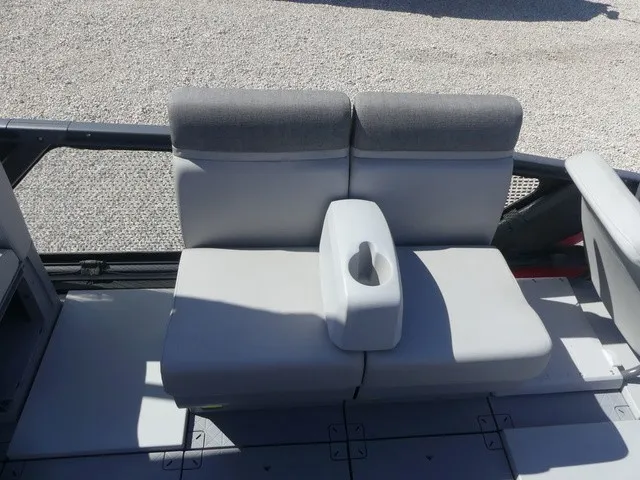 Slide: The Image of The gray bench seat on the Sea-Doo Switch Sport 21 accommodates two, featuring an armrest with a cup holder. - 12