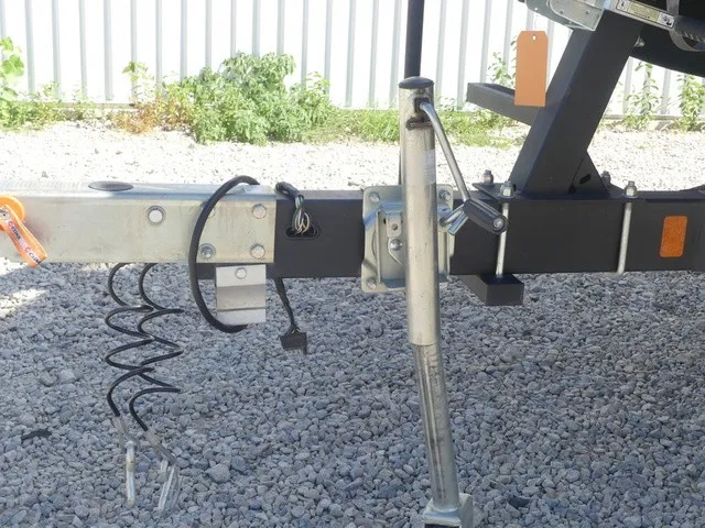 Slide: The Image of Close-up of a boat trailer with a jack stand and cables on gravel ground. - 9