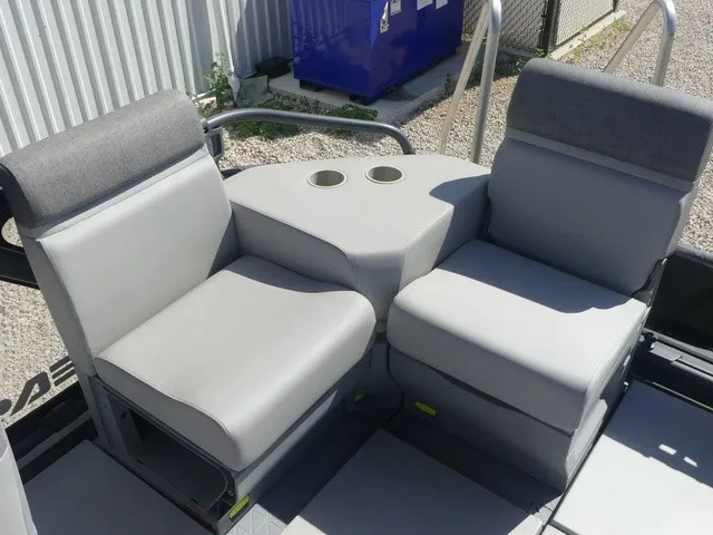 Slide: The Image of The 2023 Sea-Doo Switch Sport 21 features two gray seats with a central cup holder. - 15