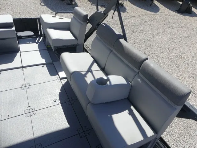 Slide: The Image of The image shows the seating of a 2023 Sea-Doo Switch Sport 21 with gray upholstery. - 13