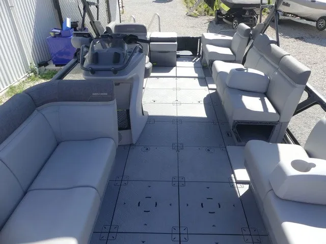 Slide: The Image of The image shows the spacious deck of a 2023 Sea-Doo Switch Sport 21 with gray seating. - 10