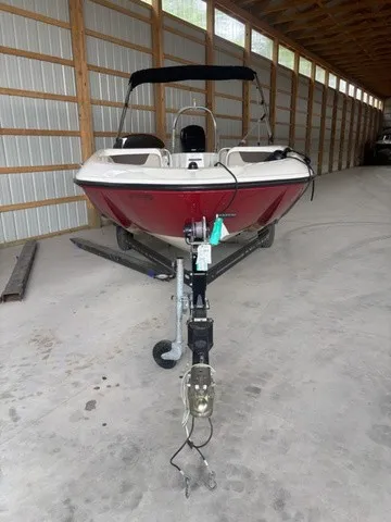 Slide: The Image of A 2016 Bayliner Element boat in a storage facility, mounted on a trailer. - 3