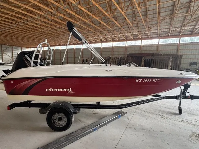 Slide: The Image of A red 2016 Bayliner Element boat on a trailer inside a warehouse. - 5